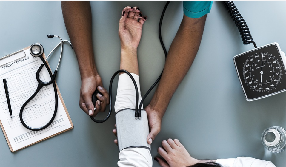 checking the blood pressure of the patients